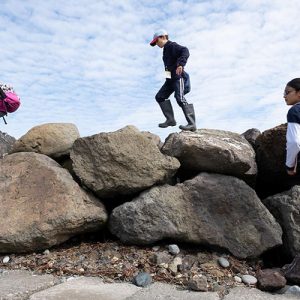 youth exploring the shore of Salish sea