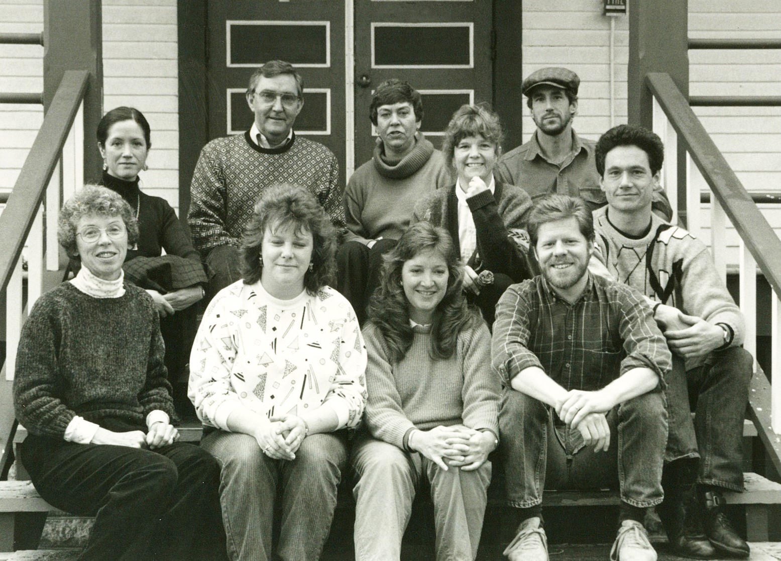 Black and white photo of Centrum Staff,sitting on the front porch of building 223.